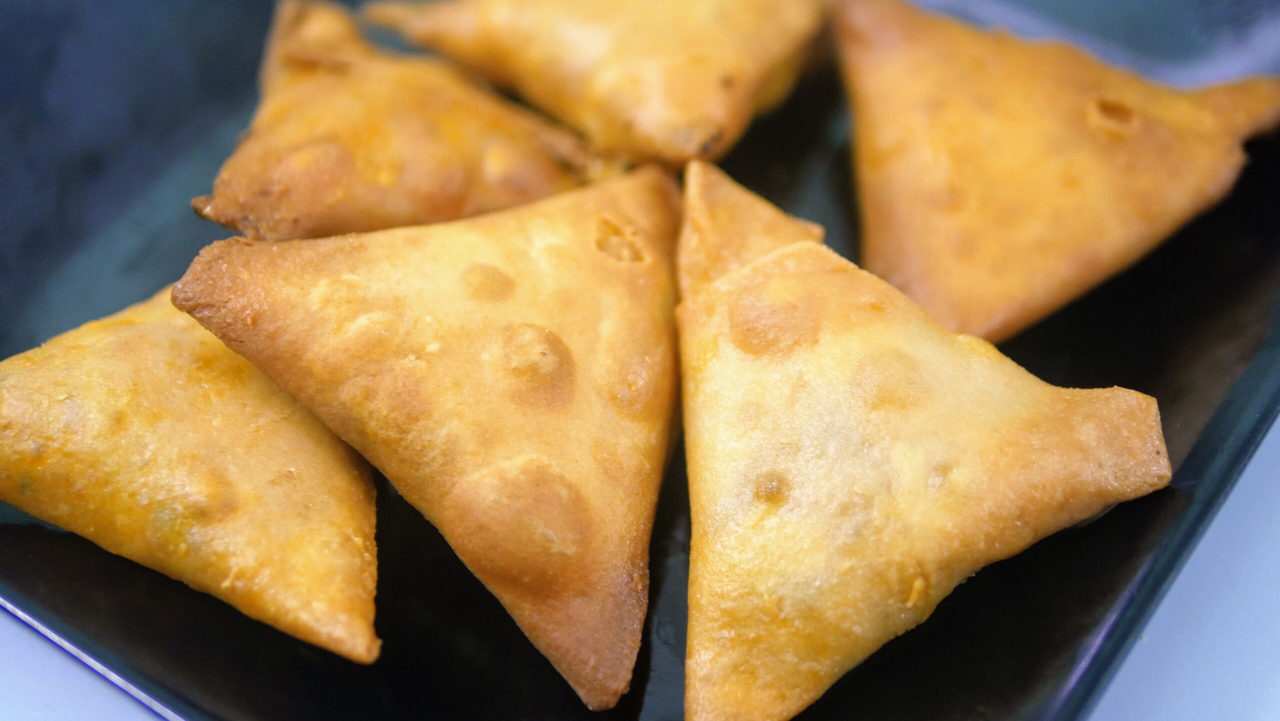 black plate with samosas